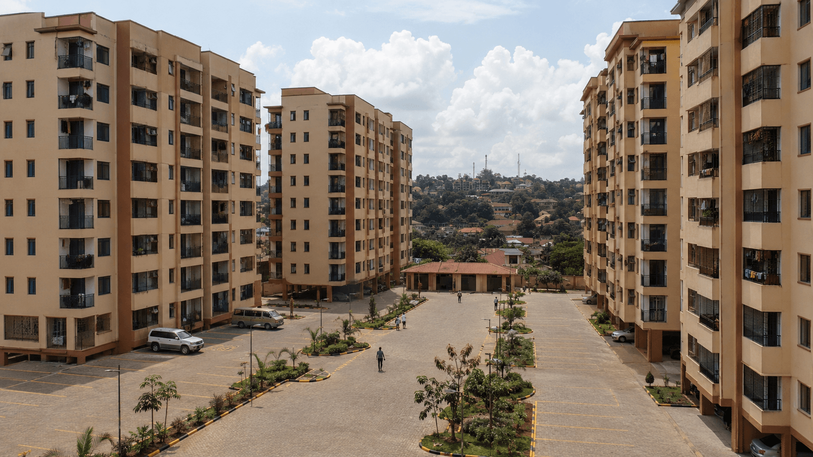 Planned affordable housing community showing organised living, access roads, greenery, and shared spaces